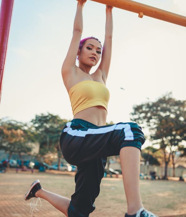 Person in a dynamic pose radiating energy and strength.